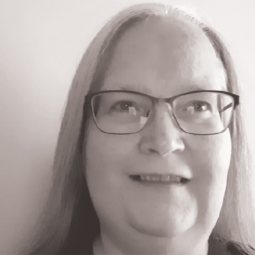 Portrait headshot photograph of Dr Margaret Healy smiling