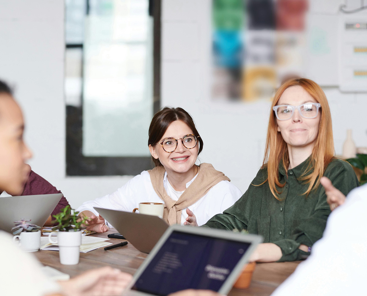 Smiling office employees at conference table